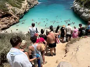 Overcrowded Mallorca Beach: Owners Apply to Restrict Access Due to Environmental Damage and Social Media's Impact